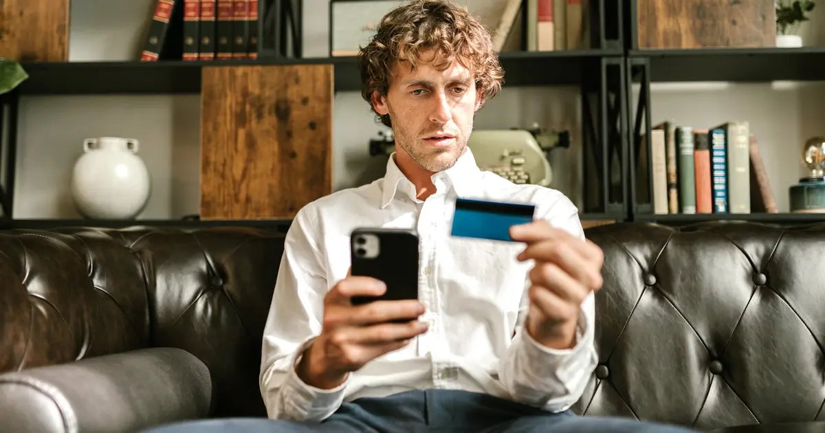 A man entering his credit card information