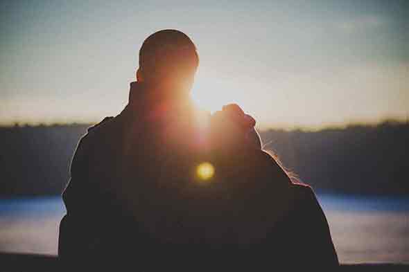A silhouette of a couple hugging